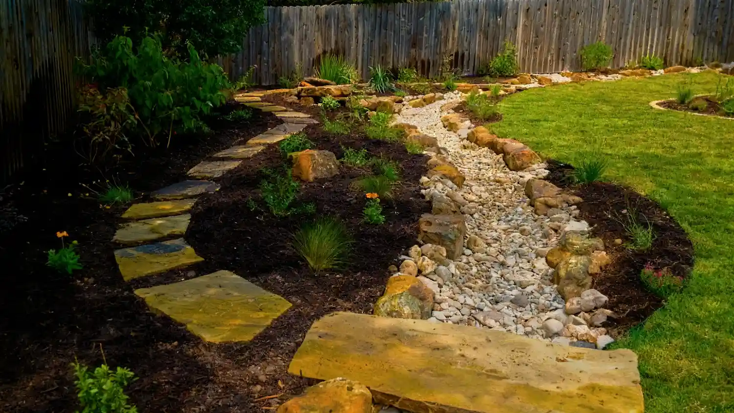 Dry creek bed with flagstone stepping stones and native plantings
